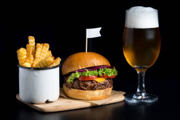 istock grilled beef bun burger salad beer fries plain background 653245812