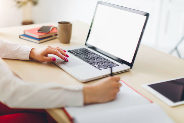 istock Close up student business hand laptop computer notes studying home 653245850