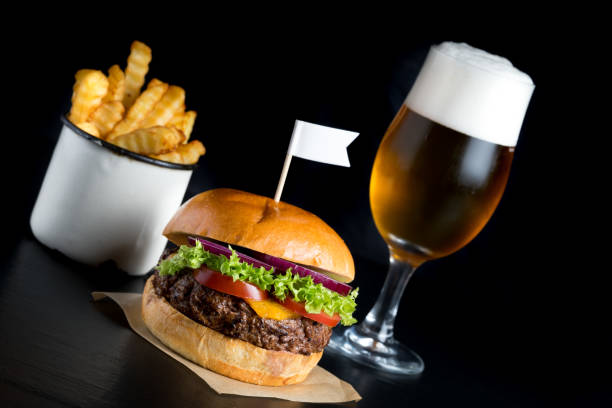 istock grilled beef bun burger salad beer fries plain background 653248454