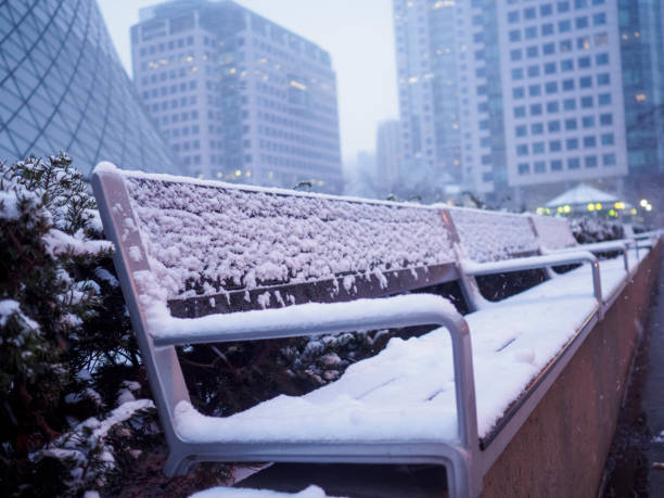 istock Empty Bench on a Snowy day in an urban city downtown 653248556