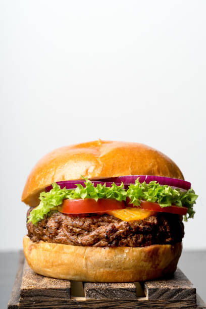istock grilled beef bun burger salad beer fries plain background 653251912