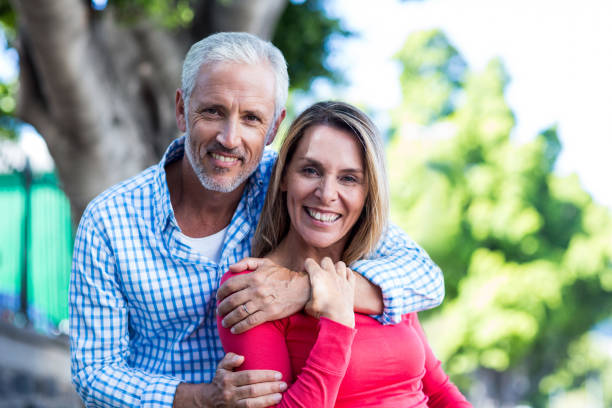 istock Portrait of romantic couple standing against tree 653254708