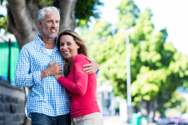 istock Smiling mature couple standing against tree 653254720