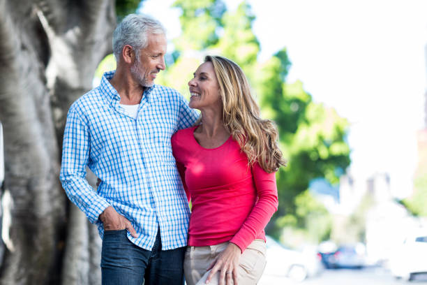 istock Romantic mature couple standing against tree 653254824