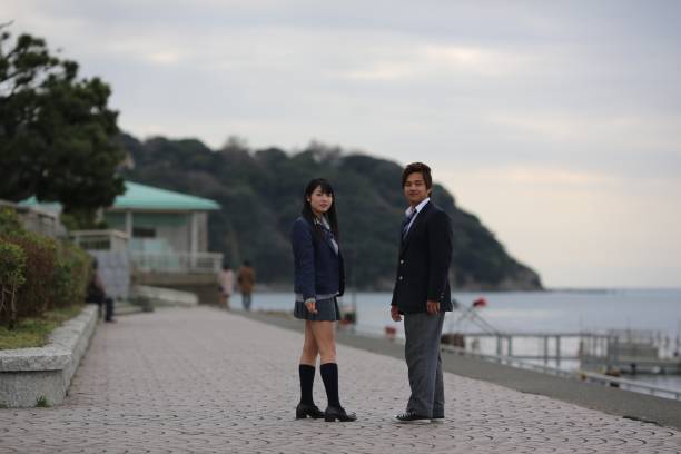istock HIgh School Student Couple Standing at Beach Side 653255434
