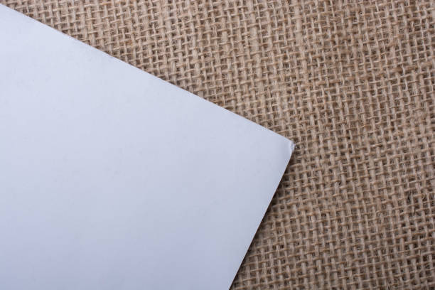 istock Piece of white paper  on a linen canvas 653258084