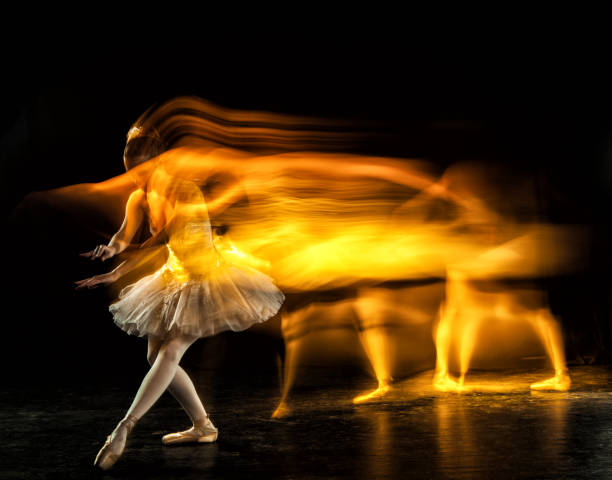 Ballerina on stage with ghosts stock photo