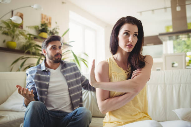 istock Upset couple arguing with each other on sofa 653261488