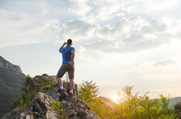 istock Man celebrating success on top of a mountain 653267494