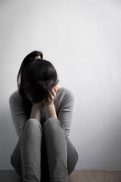 istock depression woman sit on floor 653267876