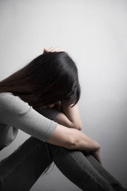 istock depression woman sit on floor 653268056