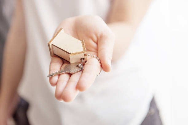 istock Female hand holding house key 653274344