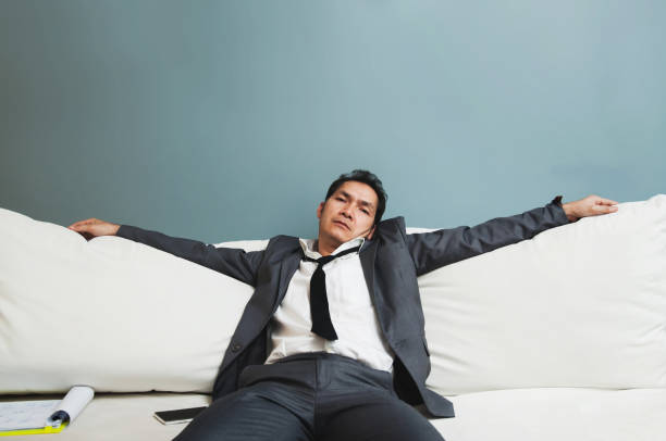 istock Exhausted, Illness, tired, stressed from overworked concepts. Businessman in grey suit sit on sofa. 653277048