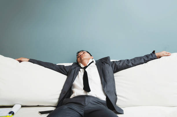 istock Exhausted, Illness, tired, stressed from overworked concepts. Businessman in grey suit sit on sofa. Senior man sleepy. 653277056