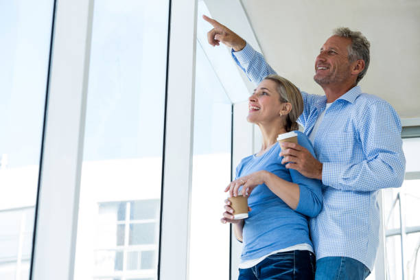 istock Smiling man pointing while standing by woman 653278186