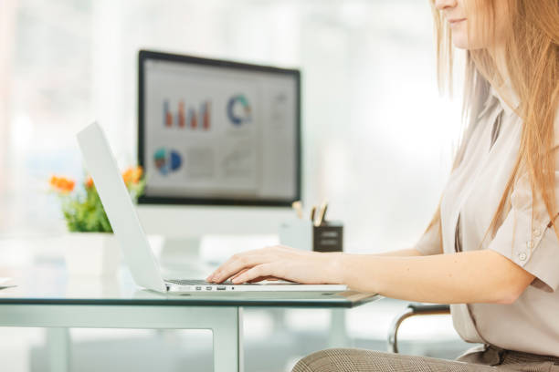 istock accountant working on a laptop with financial charts on the desktop 653281518