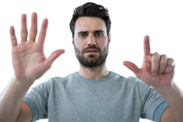 istock Man pretending to touch an invisible screen 653284370