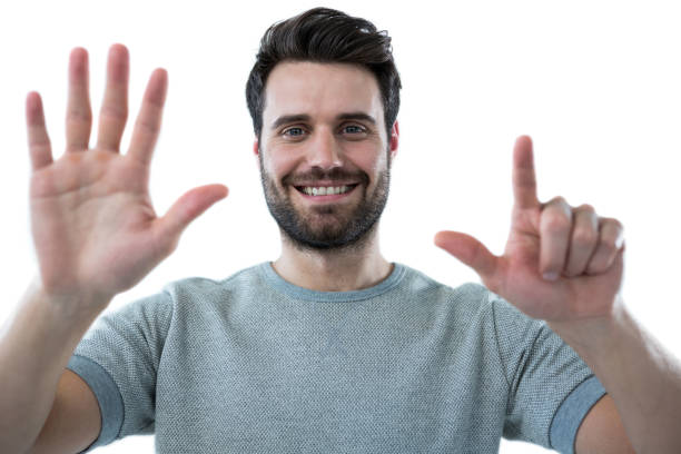 istock Smiling man pretending to touch an invisible screen 653284390