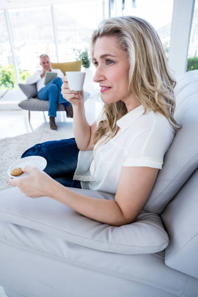 istock Smiling woman having coffee at home 653287094