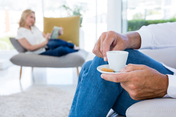 istock Midsection of man having coffee at home 653287132