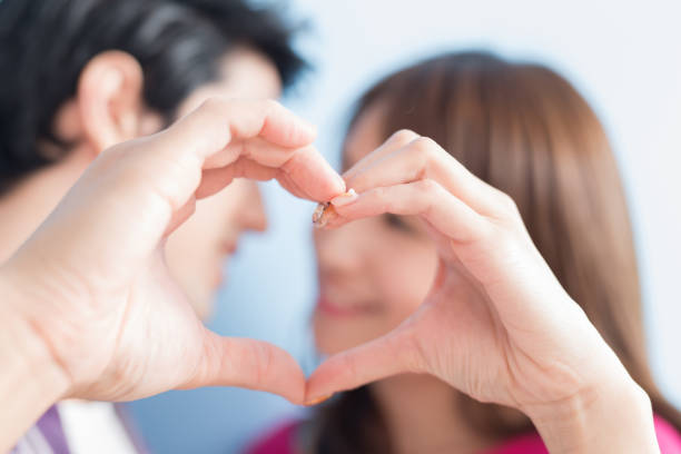 Romantic couple on valentine's day. The Man and woman hands, holding heart. close up. love story concept.