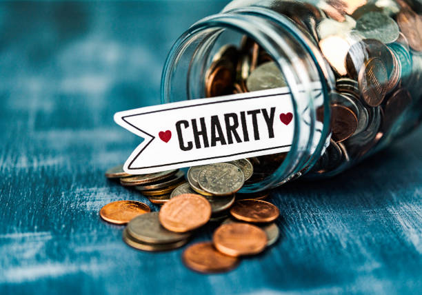 istock Charity savings jar filled with coins 653294278