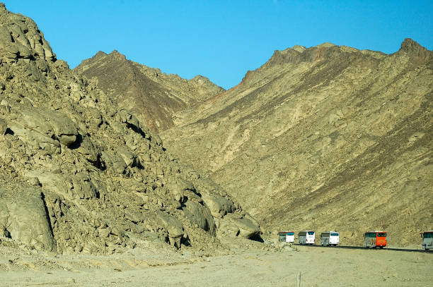 Hurghada, Egypt - November 13, 2006: The modern tourist buses move on mountain road in Egypt