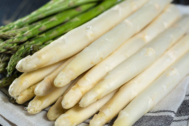 istock Spring season - fresh white and green uncooked asparagus 653307848