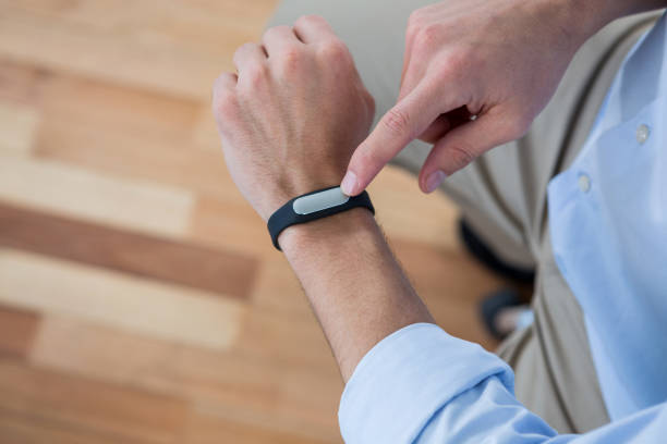 istock Man hand using a fitness band 653310752