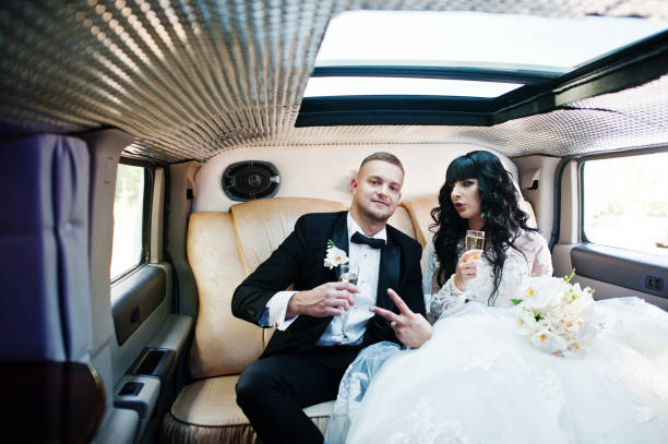 istock Amazing wedding couple inside elegance limousine at their awesome wedding day 653311674