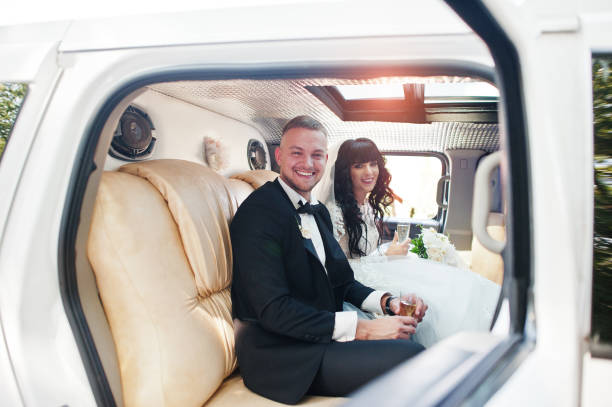 istock Amazing wedding couple inside elegance limousine at their awesome wedding day 653311676