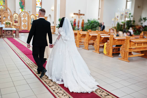 istock Glamourus wedding couple on church ceremony at their day. 653311708