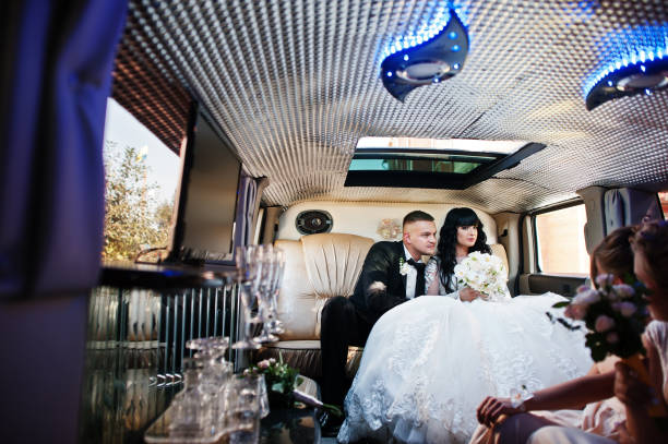 istock Amazing wedding couple inside elegance limousine at their awesome wedding day 653311772