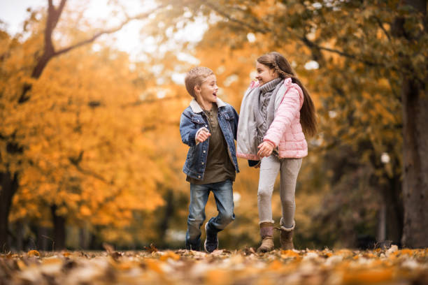 istock Happy kids having fun while running and talking in nature. 653311780