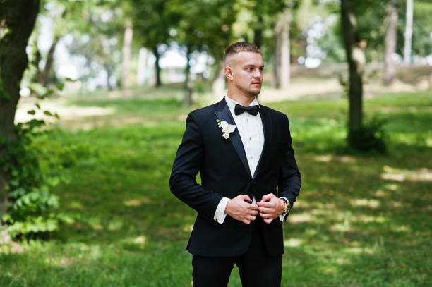istock Trendy beard man groom with bow tie posed on park. 653313912