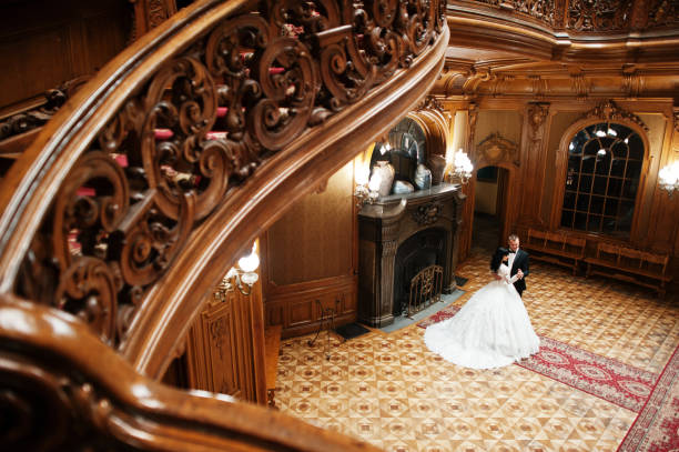 istock Royal wedding couple background big stone fireplace at the palace. 653315084