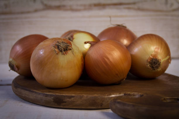 istock Fresh onions on a wooden board 653315120