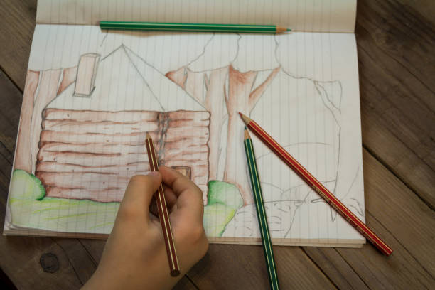 istock The girl draws a house 653318462