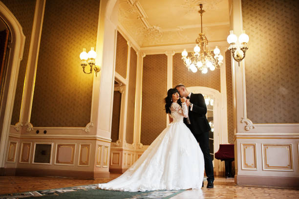 istock Fairy wedding couple on golden palace at arch. 653325574
