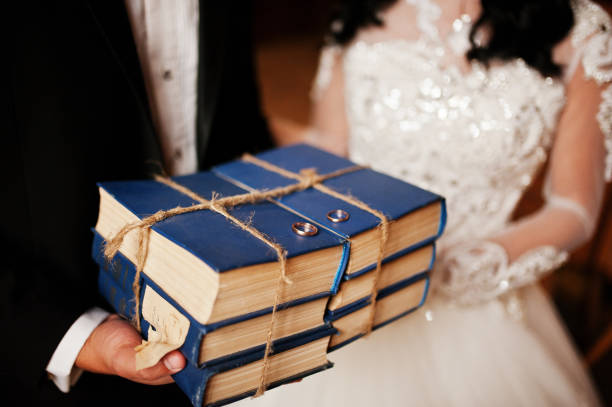 istock Wedding couple on old wooden library at their wedding day. 653325622