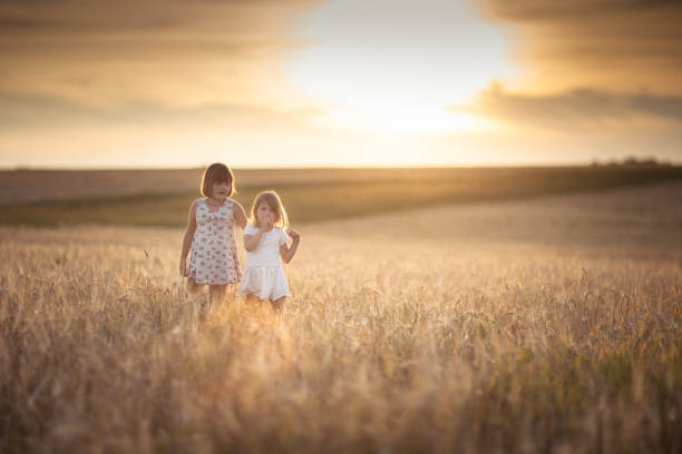 istock Children happiness in the field with rye 653330610