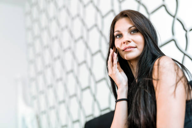 istock Beautiful young woman using phone and calling while smiling 653331644
