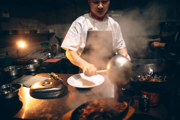 Photo of a Chinese chef preparing food in the kitchen of Chinese restaurant