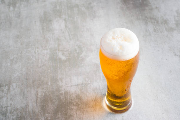 istock Glass of beer with on concrete table 653344152