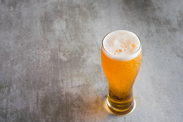istock Glass of beer with on concrete table 653344262