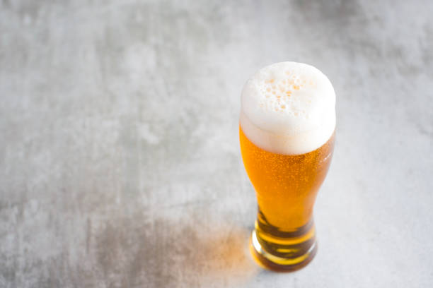 istock Glass of beer with on concrete table 653344304