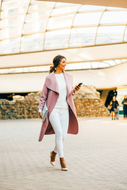 istock Beautiful elegant woman texting on the phone 653345004