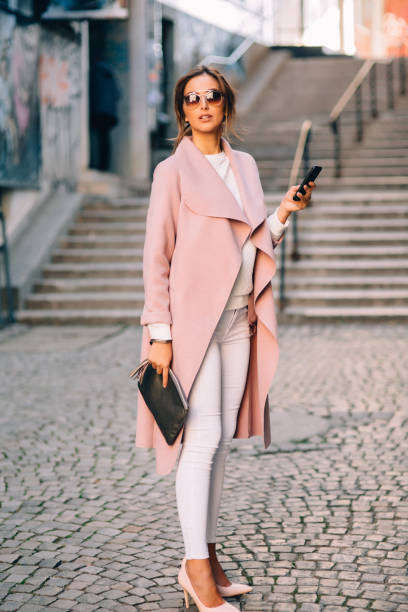 istock Beautiful elegant woman texting outdoors 653345016