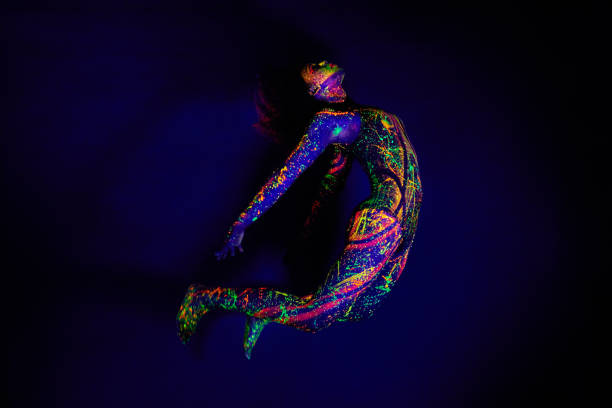 Full length shot of a young woman posing with neon paint on her face