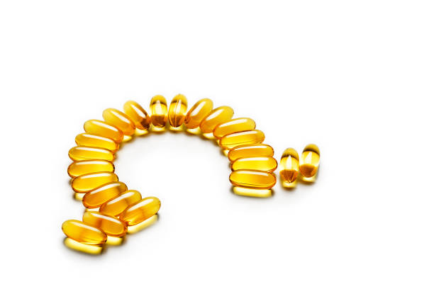 istock Omega-3 capsules - letter shape, isolated on white background 653347750